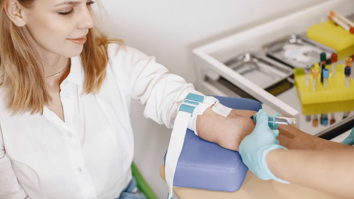 Gestational Diabetes Screening Results: What a Failed Glucose Test Means Clinician drawing blood from a seated patient