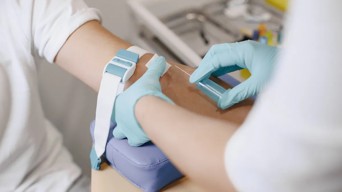 Blood draw from an arm into a tube