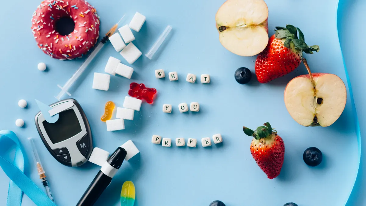 Impact of Gestational Diabetes on Fetal Development — Letter Dices Between Fresh Fruits and Diabetes Equipment on a Blue