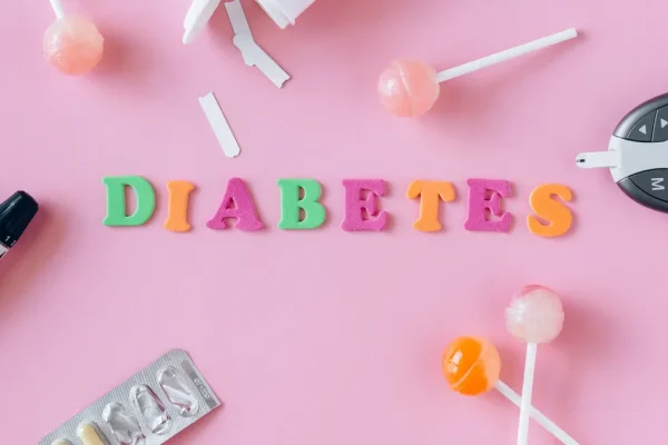 Long-term Health Risks of Gestational Diabetes — Word "Diabetes" Made of Colorful Letters Lying among Lollipops, Medicat