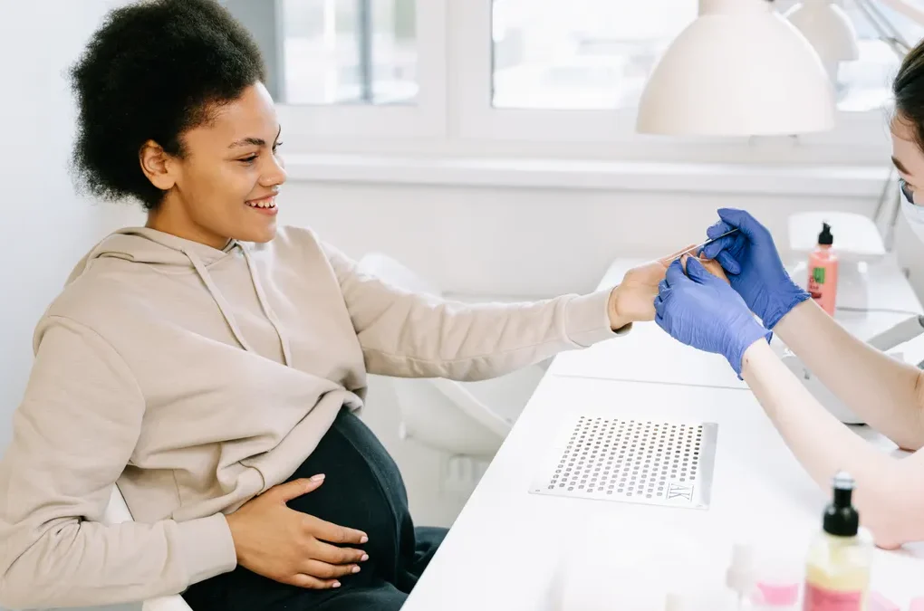 Pregnant woman getting a blood sample in a clinic
