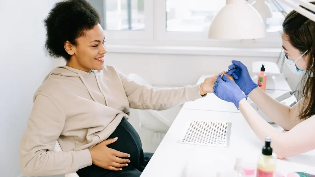 Pregnant woman getting a blood sample in a clinic